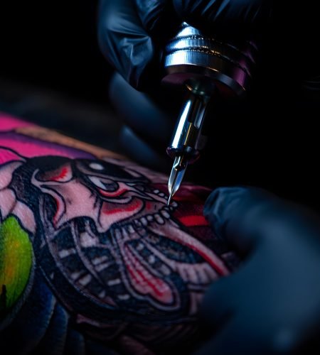 vecteezy_tattoo-artist-inking-detailed-colorful-snake-design-on_68912278